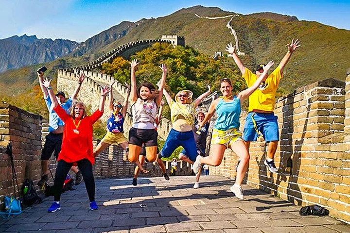 Travelers celebrating their Great Wall visit