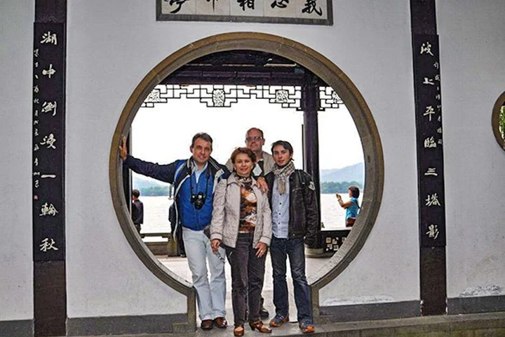 Travelers at a traditional West Lake garden in Hangzhou