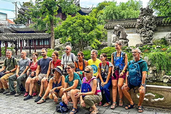 A travel group visiting a traditional garden in Shanghai