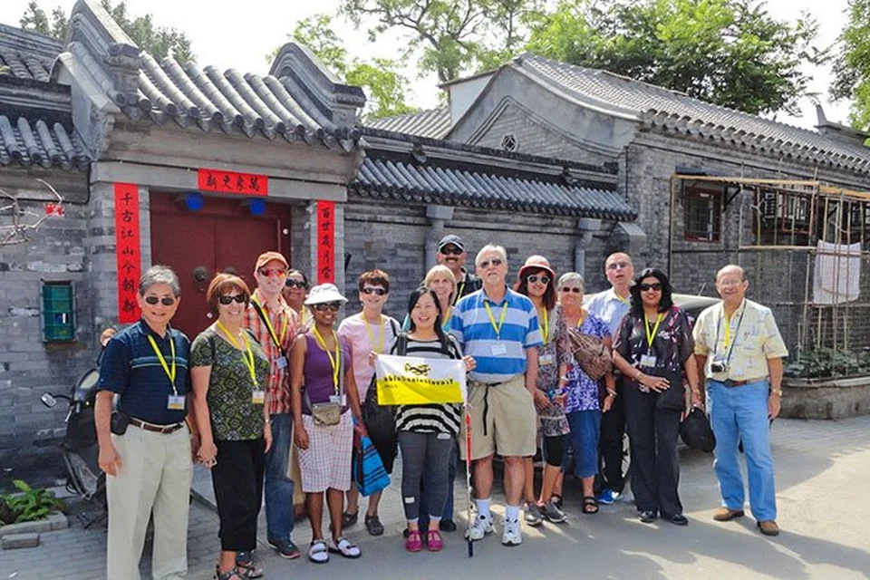 Travelers visiting a traditional hutong courtyard in Beijing
