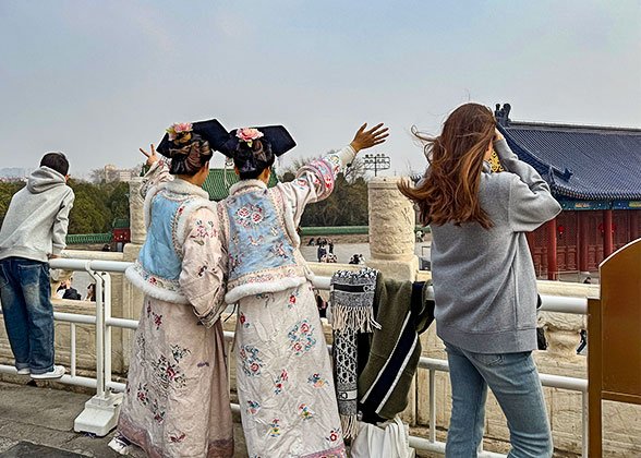 Visitors on Red Stairway Bridge