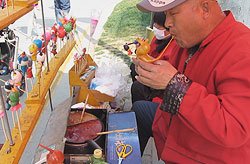 Blowing traditional Chinese sugar figurines