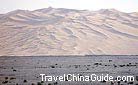 Pyramid sand dunes with rolling ridges and steep crests in Dunhuang are as mysterious and attractive as its cultural relics.