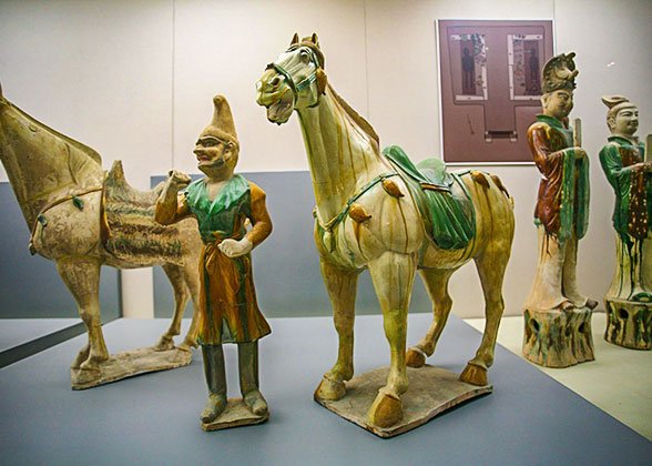 Tri-color figures of horses and groom