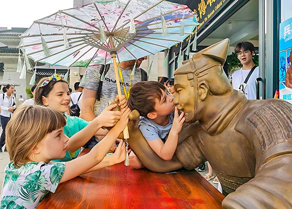 Children Showing Their Love to the Terracotta Figure Children Showing Their Love to the Terracotta Figure