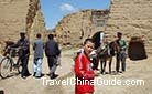 A boy standing in front of the grand Great Wall.